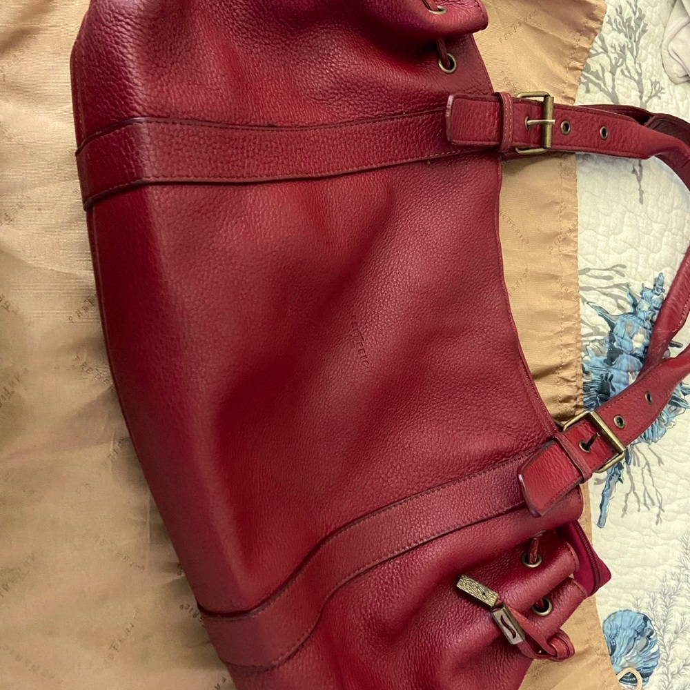Lg hobo leather bag with original Frederic T gold storage bag. Great condition.
